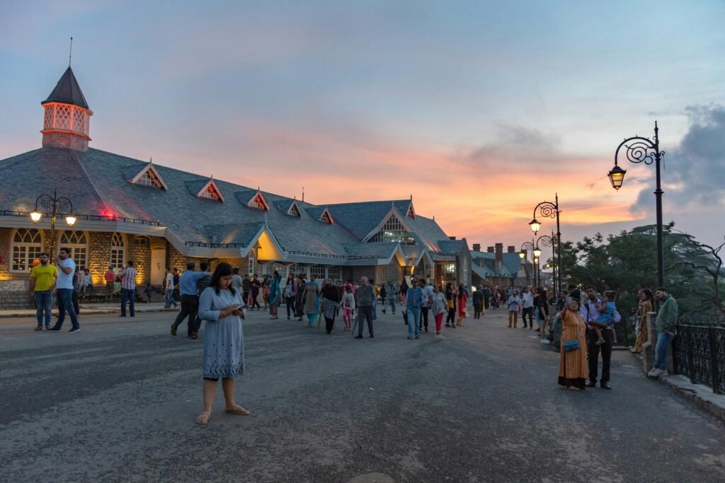 Evening scene with people near Indian landmark during sunset.