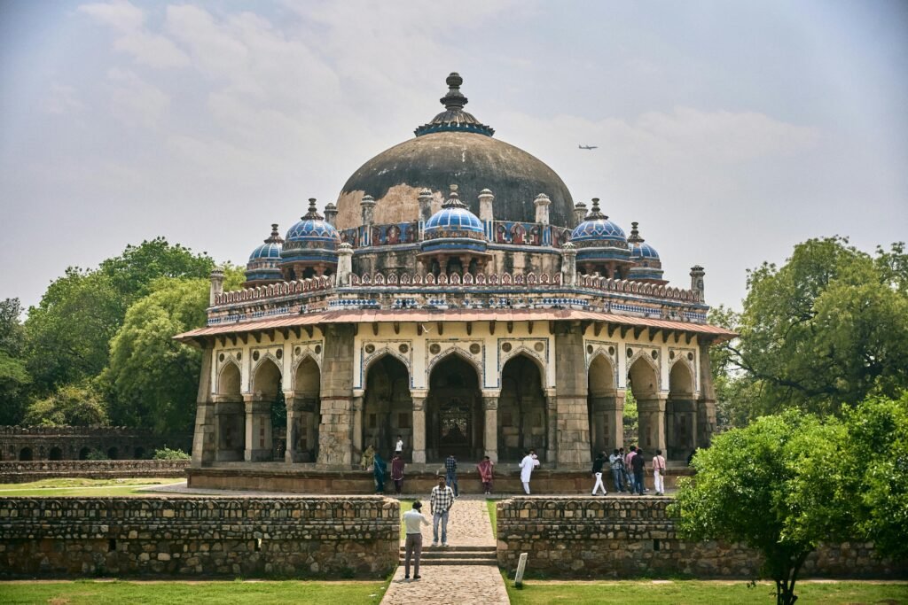 The majestic Isa Khan's Tomb stands amidst lush greenery in Delhi, showcasing Mughal architecture.